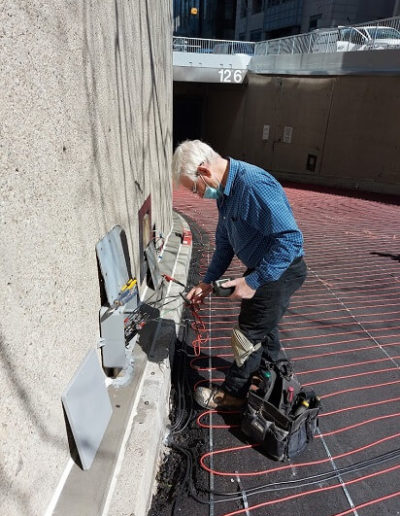 Ramp heating cable being tested by electrician