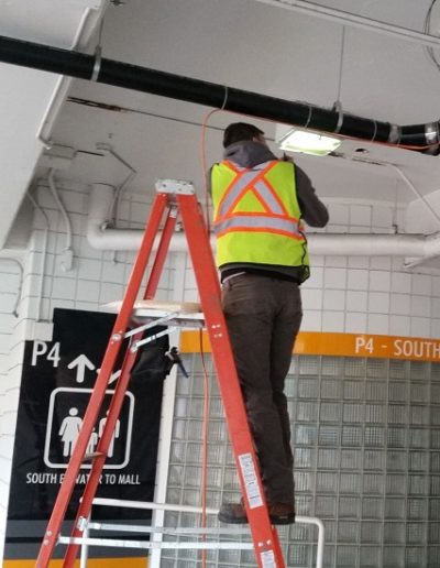 Electrician installing self regulating pipe tracing heating cable